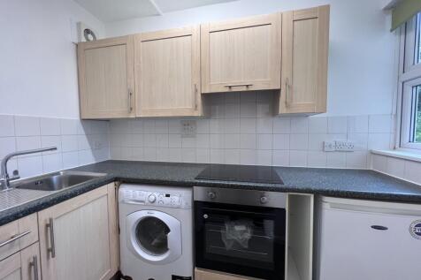 A modern kitchenette featuring essential applia...