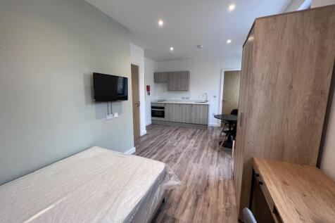 A bright and modern kitchenette with ample spac...