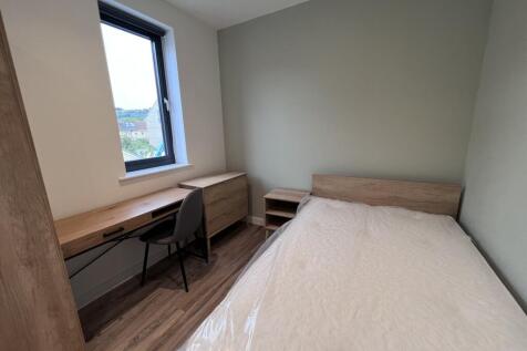 A bright and inviting double bedroom featuring ...