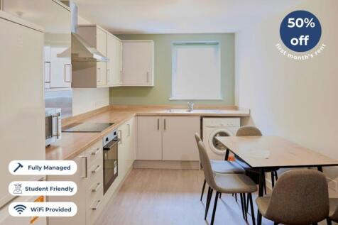 A modern kitchen featuring sleek cabinetry, a s...