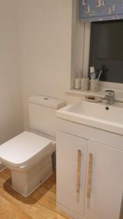 A bright and tidy bathroom featuring modern fix...