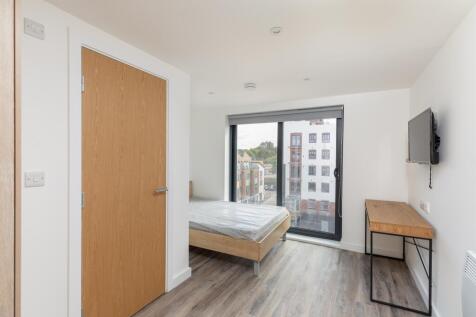 A bright and spacious double bedroom featuring ...