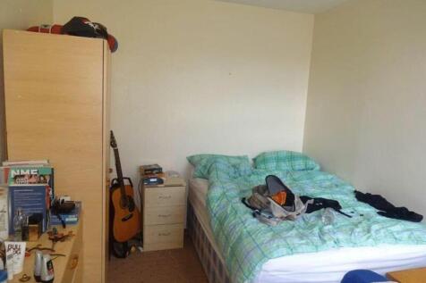 A cozy double bedroom with a comfortable bed an...