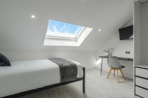 A bright and inviting double bedroom featuring ...