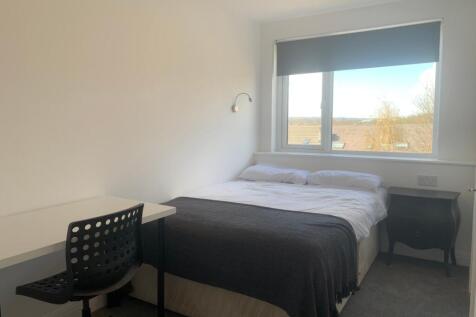 This inviting double bedroom features a comfort...