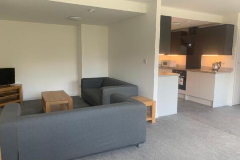 Spacious and modern living room featuring comfo...