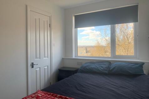 This cozy double bedroom features a large windo...