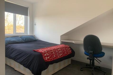 A cozy double bedroom featuring a comfortable b...