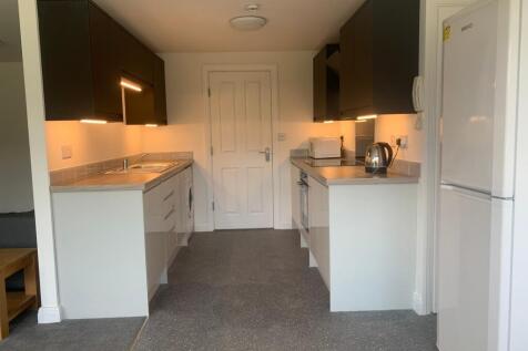 Modern kitchen featuring sleek cabinetry and am...