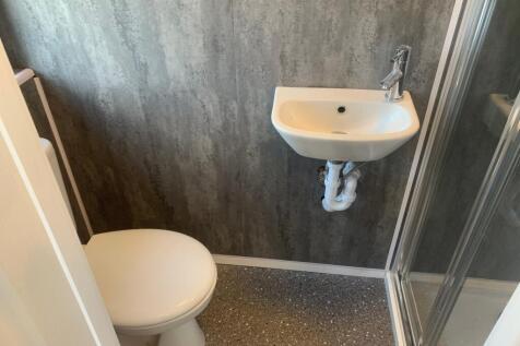 A modern bathroom featuring a sleek shower and ...