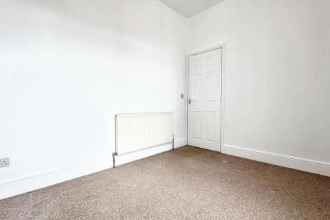 A bright and inviting single bedroom featuring ...