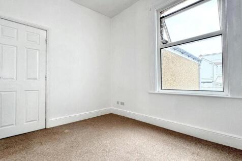 This inviting double bedroom features a large w...