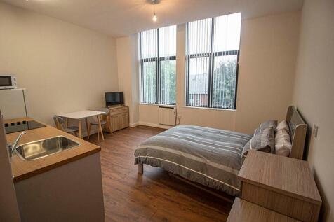 Spacious double bedroom featuring large windows...