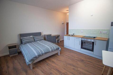 This inviting double bedroom features a comfort...