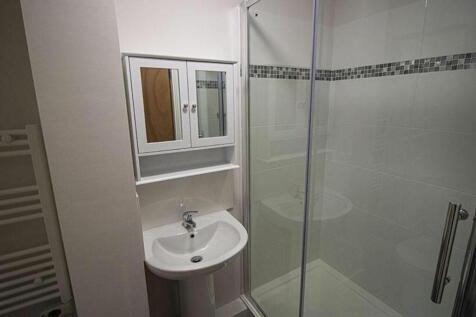 This modern bathroom features a sleek shower ar...