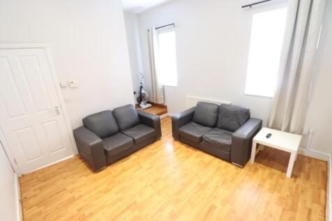 A bright and inviting living room featuring con...