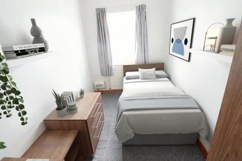 A cozy double bedroom featuring a comfortable b...