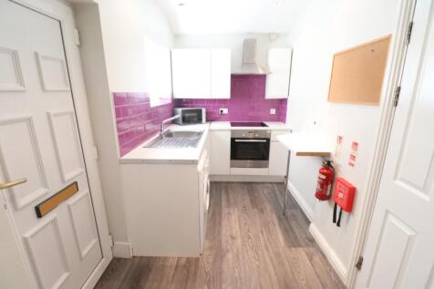 A bright and modern kitchen featuring sleek cab...