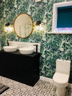 This spacious bathroom suite features elegant d...
