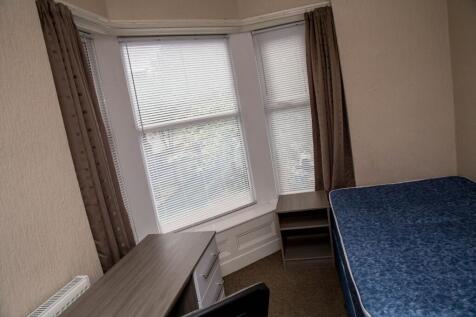Spacious double bedroom featuring large windows...