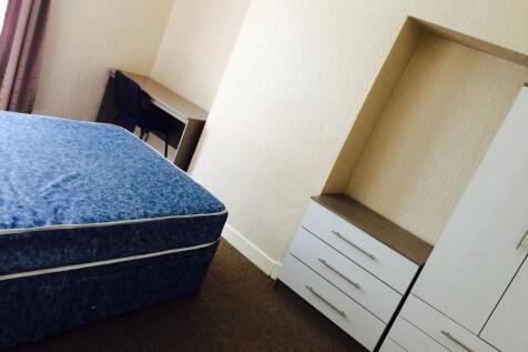 Spacious double bedroom featuring a comfortable...
