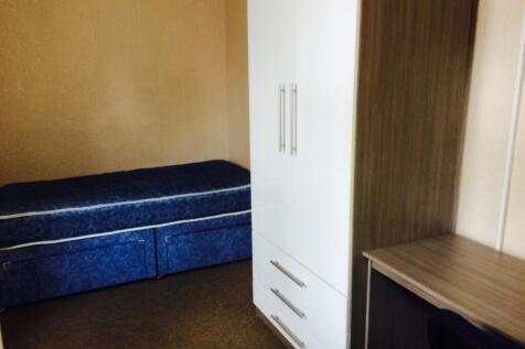 Cozy double bedroom featuring a comfortable bed...
