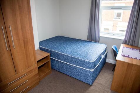 Cozy double bedroom featuring a comfortable blu...