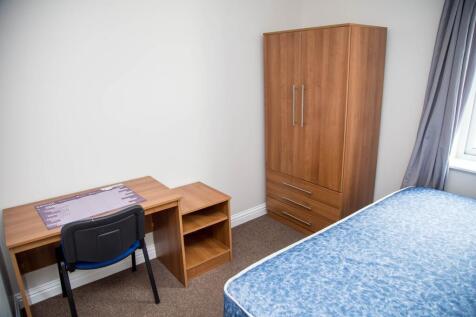 A well-furnished double bedroom featuring a com...