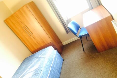 This inviting double bedroom features a comfort...