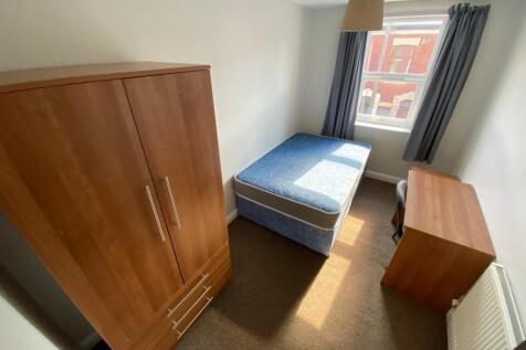 Spacious double bedroom featuring ample natural...