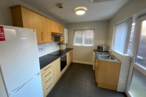 A modern kitchen featuring ample storage with s...