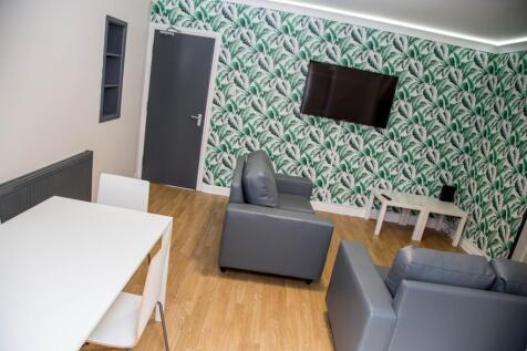 A stylish communal lounge featuring modern furn...