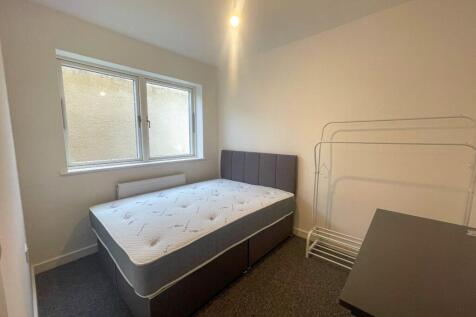 This cozy double bedroom features a comfortable...