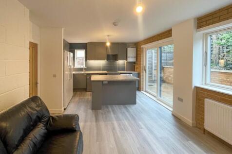 Spacious and modern kitchen area featuring slee...