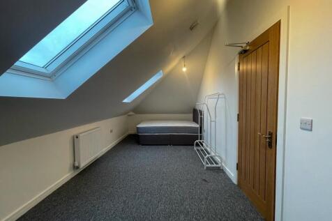 This spacious double bedroom features a large w...