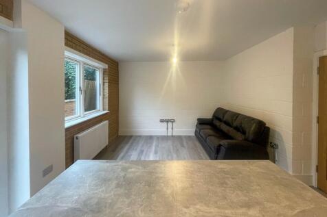 Bright and spacious living room featuring large...
