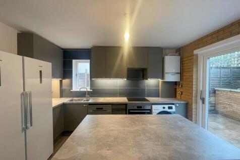 This modern kitchen features a spacious layout ...