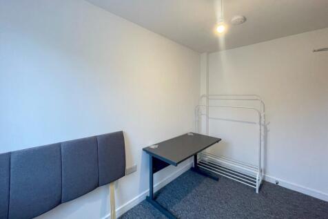This inviting double bedroom features a comfort...
