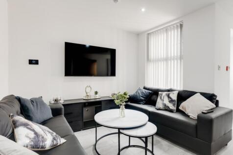 A bright and inviting large modern living room ...