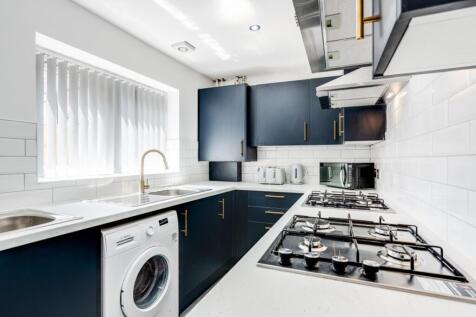 A modern and well-equipped kitchen featuring sl...