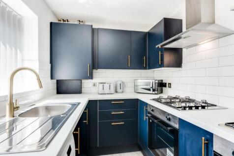 A modern and stylish kitchenette with ample sto...