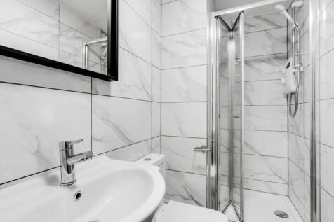 A modern and pristine bathroom with stylish fin...