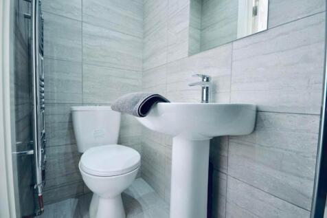 A modern and spotless bathroom featuring sleek ...