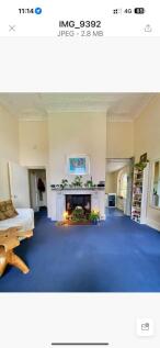 Spacious living room featuring a cozy fireplace...