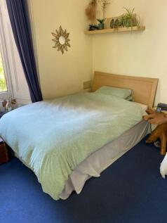 A cozy double bedroom featuring a comfortable b...