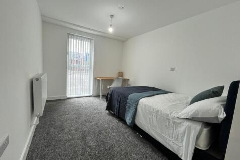 Spacious double bedroom featuring a comfortable...