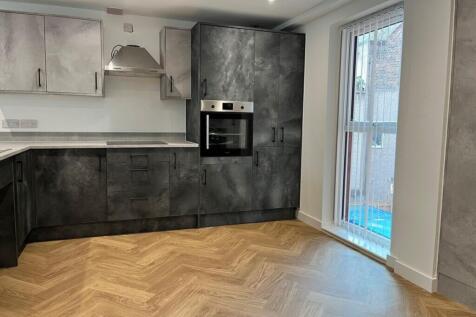 Modern kitchen featuring sleek cabinetry and am...