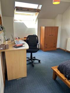 A cozy double bedroom featuring a comfortable b...