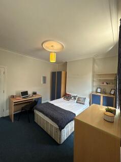 A cozy double bedroom featuring a comfortable b...
