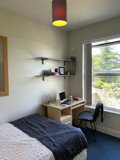 A cozy double bedroom featuring a comfortable b...